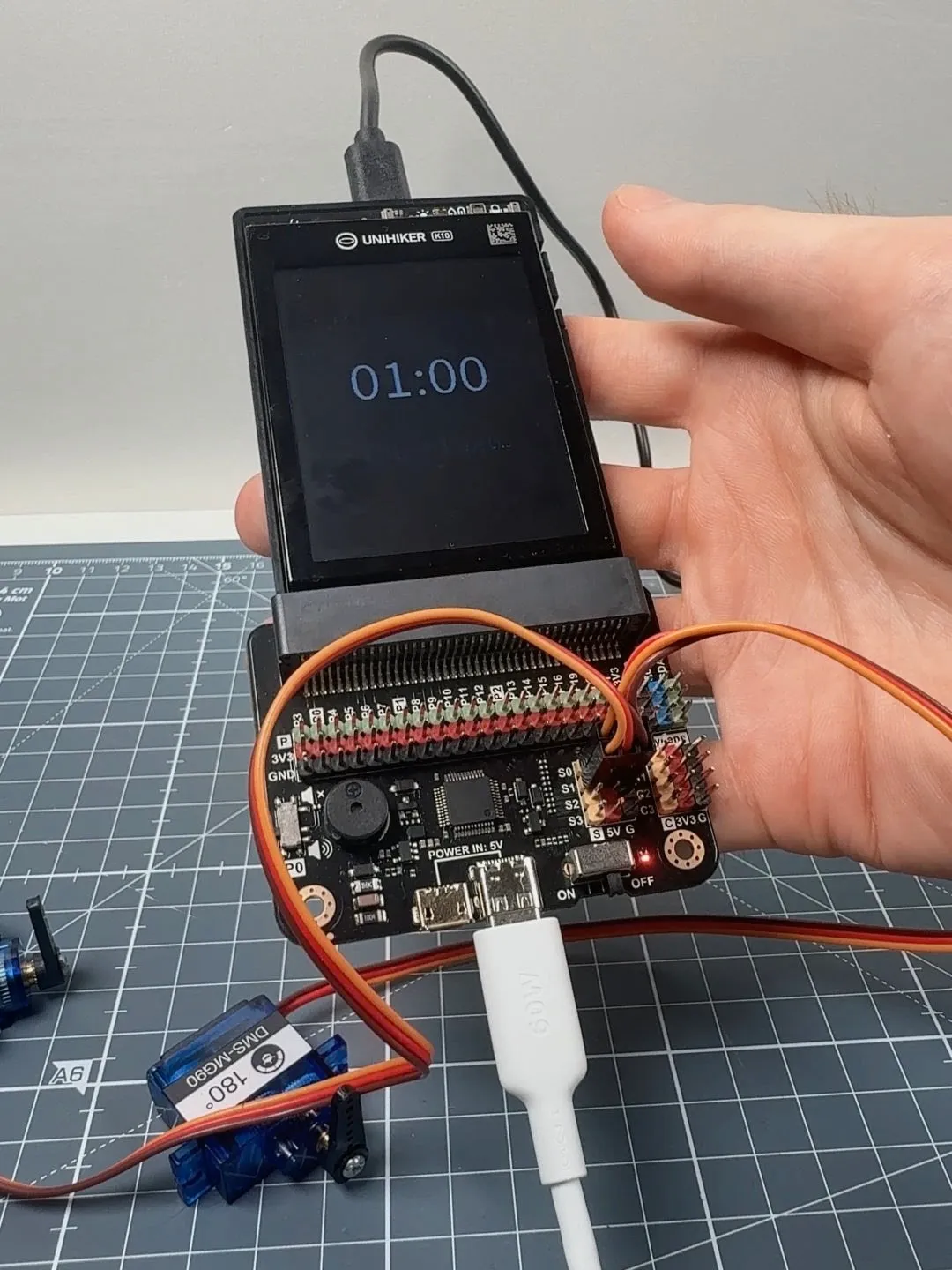 The UNIHIKER K10 connected to the Extension board with servos